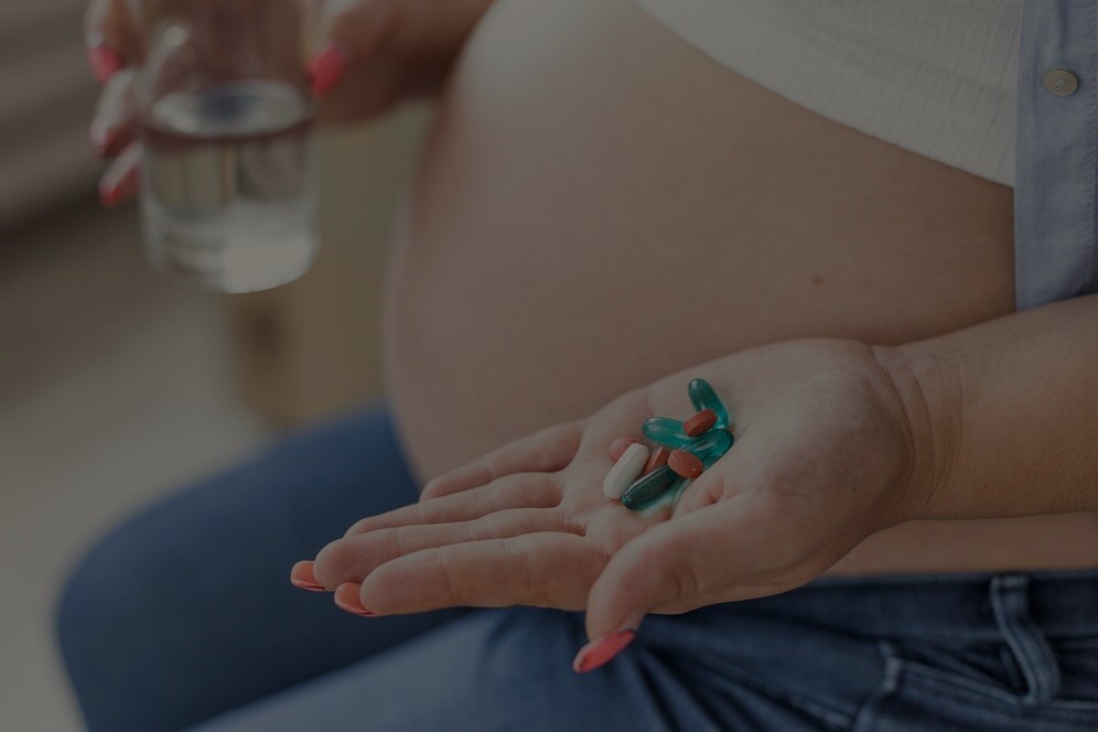 side-view-pregnant-woman-holding-her-pills_23-2148302047