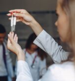 men-women-hospital-gowns-study-nurse-with-test-tubes_1157-41698